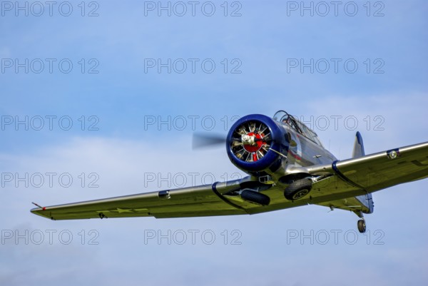 A North American AT-6D with the registration D-FAML during a flight demonstration as part of an air show at the Rossfeld in Metzingen-Glems, Baden-Württemberg, Germany, for editorial use only