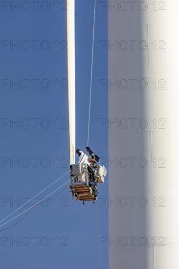 Luverne, Minnesota - Workers repair the cracked blade of a wind turbine