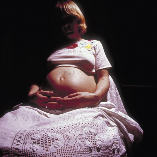 Pregnant woman with her hands on her stomach, Bavaria, Germany