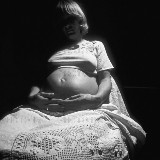 Pregnant woman with her hands on her belly, black and white, Bavaria, Germany