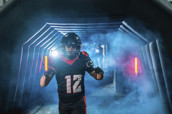 American football player with helmet and uniform running from a smoky tunnel with blue and red lights, creating a dramatic entrance at a sports stadium
