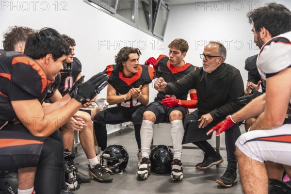 American football coach briefing players in a locker room, outlining strategy and motivating the team before or during the game, focused leadership and determined preparation
