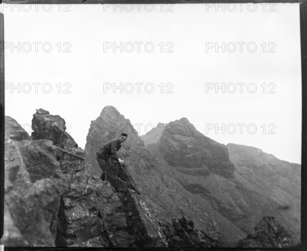 Climber on rocks, Cuillin mountains, Skye, Scotland, UK c 1900-1920 colourised image