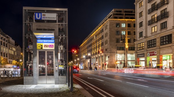 Night photo, long exposure with motion blur, modern lift at Unter den Linden underground station, contemporary design with bright lighting, U5 and U6 lines, Berlin, Germany