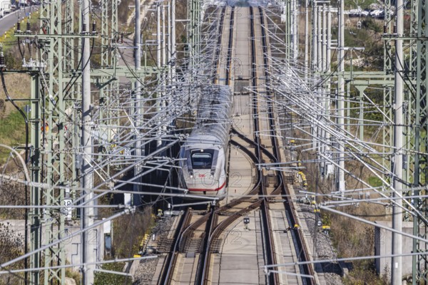Deutsche Bahn AG high-speed railway line between Stuttgart and Ulm. New railway line with ICE of Deutsche Bahn AG with overhead lines and railway technology. Kirchheim unter Teck, Baden-Württemberg, Germany