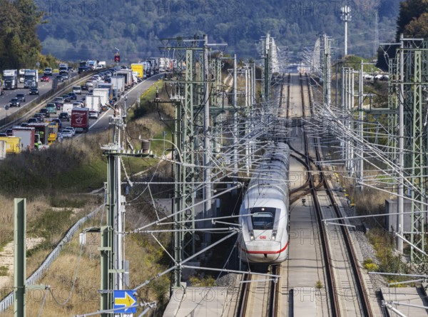 A8 motorway with traffic jam. The new high-speed railway line of Deutsche Bahn AG runs parallel between Stuttgart and Ulm. New railway line with Deutsche Bahn AG ICE with overhead lines and railway technology. Kirchheim unter Teck, Baden-Württemberg, Germany