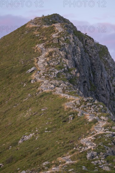 Upper section of the Rørsethornet stone staircase, with 3292 steps one of the longest continuous stone staircases in the world, Sherpat stairs or Midsund stairs or Midsundtrappene, Rørsethornet hike, warm evening light, Otroya or Otrøya island, Møre og Romsdal, Norway