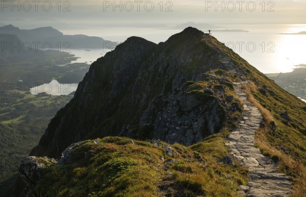 Hikers on the Rørsethornet stone staircase, with 3292 steps one of the longest continuous stone staircases in the world, Sherpatreppe or Midsundtreppe or Midsundtrappene, Rørsethornet hike, evening mood, Otroya or Otrøya island, Møre og Romsdal, Norway