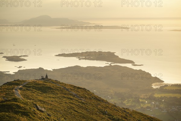 Cairns and view over islands and sea, evening mood, Rørsethornet stone staircase, with 3292 steps one of the longest continuous stone staircases in the world, Sherpat staircase or Midsund staircase or Midsundtrappene, Rørsethornet hike, Otroya or Otrøya island, Møre og Romsdal, Norway