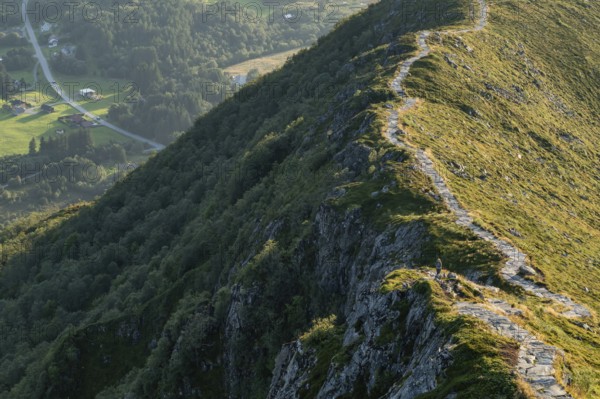 Woman standing on section of the Rørsethornet stone staircase, with 3292 steps one of the longest continuous stone staircases in the world, Sherpatreppe or Midsundtreppe or Midsundtrappene, Rørsethornet hike, Otroya or Otrøya island, Møre og Romsdal, Norway