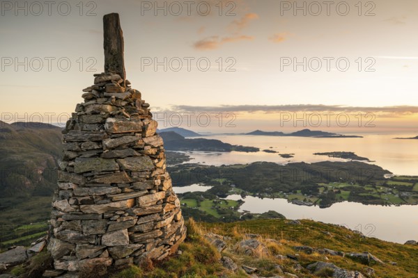 View of the Norwegian coast from the Rørsethornet stone steps, with 3292 steps one of the longest continuous stone steps in the world, Sherpat stairs or Midsund stairs or Midsundtrappene, Rørsethornet hike, cairns, evening mood, Otroya or Otrøya island, Møre og Romsdal, Norway