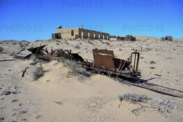 Wagon of an old narrow-gauge railway in the desert sand, Pomona, restricted diamond area, near Lüderitz, Karas region, Namibia