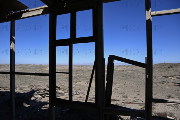 View from a dilapidated building into the desert, Pomona, restricted diamond area, near Lüderitz, Karas region, Namibia