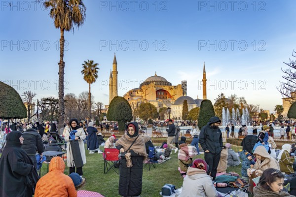 Muslims at an evening Ramadan picnic in the park in front of the Hagia Sophia mosque in Istanbul, Turkey