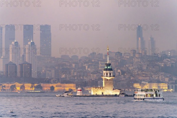 The Maiden Tower lighthouse, Leander Tower or Maiden Tower in front of the Istanbul skyline at dusk, Turkey