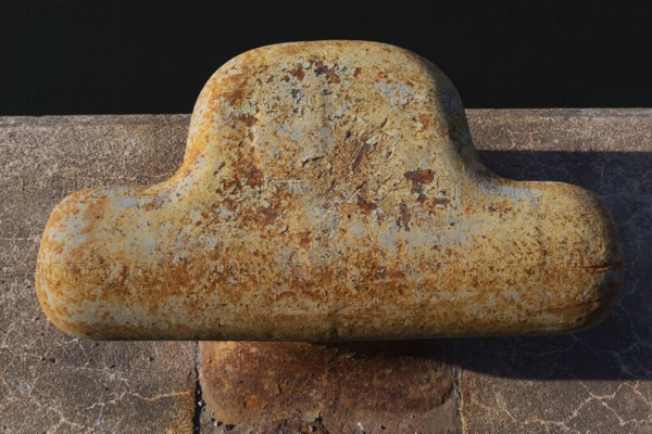 Close-up of bollard with flaking paint and rust spots on King Edward pier in Old Port of Montreal, Quebec, Canada