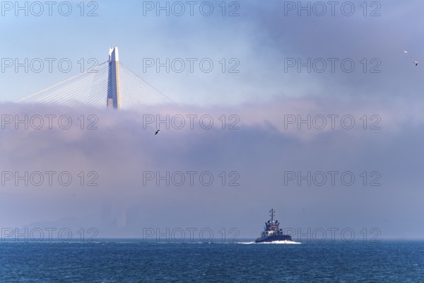 Coast Guard boat on the Bosphorus in front of the Yavuz Sultan Selim Bridge in the fog near Istanbul, Turkey