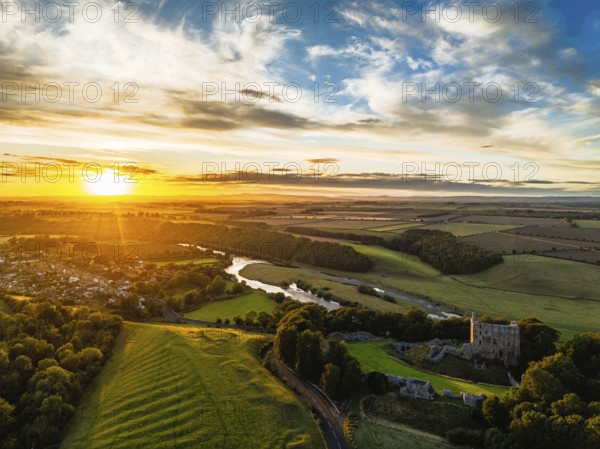 Sunset over Norham Castle and River Tweed from a drone, Norham, Northumberland, England, United Kingdom