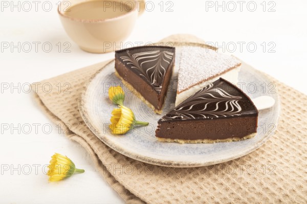 Chocolate and Vanilla Cake pops Marshmallow with cup of coffee on white wooden background and beige linen textile. side view, close up