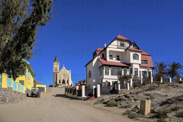 Colonial house facade in the Kirchstraße, in the background the rock church, Lüderitz, Karas region, Namibia