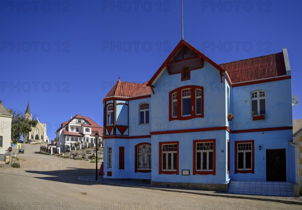 Colonial house facade in the Bergstraße, in the background the rock church, Lüderitz, Karas region, Namibia