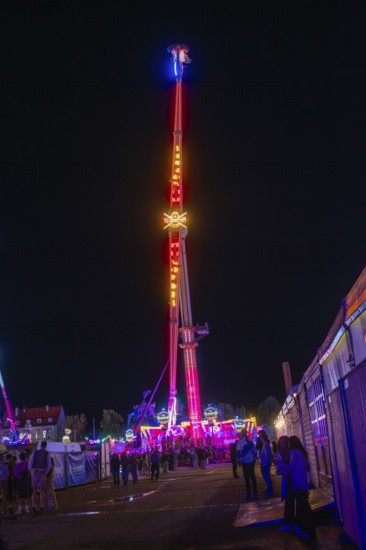 An impressive illuminated ride at a night fair, Cannstatter Wasen funfair, Stuttgart, Germany