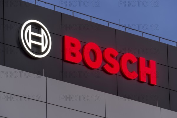 Bosch logo illuminated on the building façade against a blue night sky, Waiblingen, Baden-Württemberg, Germany