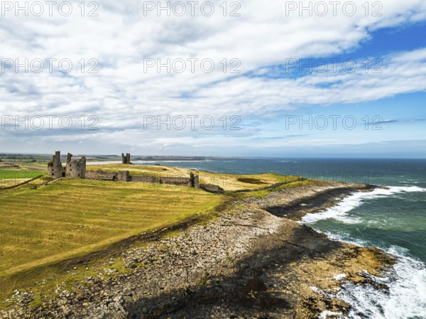 Dunstanburgh Castle from a drone, Northumberland Coast, England, United Kingdom