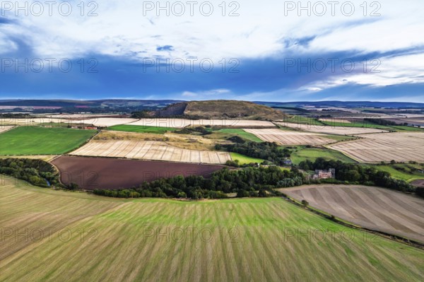 Sunset of Fields and Farms over Traprain Law and Hailes Castle from a drone, River Tyne, Haddington, East Lothian, Scotland, UK
