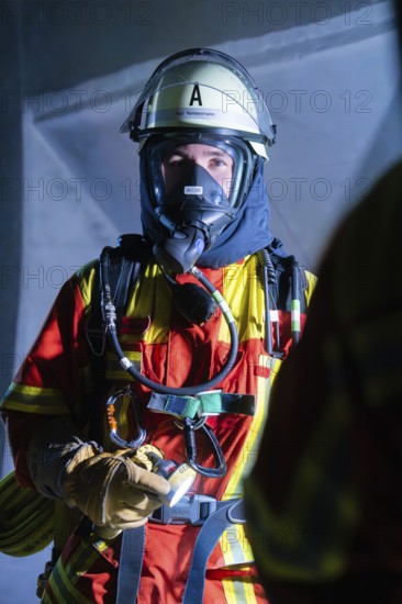 Firefighter with breathing mask and protective clothing in a building, firefighting exercise in the new construction tunnel of the Hermann Hesse railway, Ostelsheim, Calw district, Germany