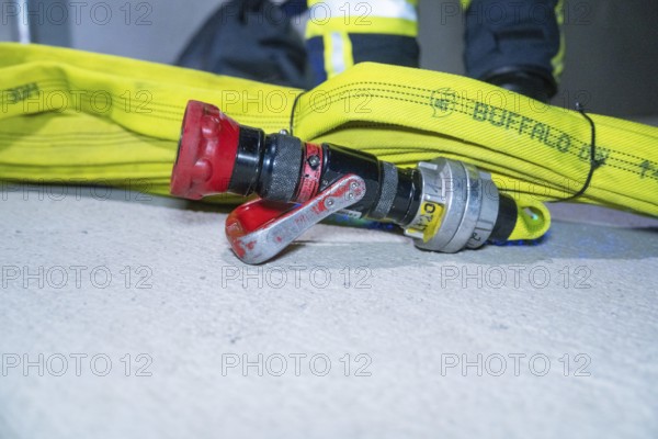 Fire hose with connected valve lying on the ground, emergency situation, firefighting exercise in the new construction tunnel of the Hermann Hesse railway, Ostelsheim, Calw district, Germany