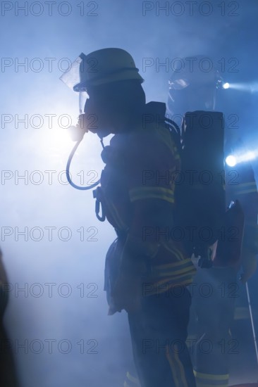 Firefighters with breathing masks in a foggy environment with bright light, firefighting exercise in the new construction tunnel of the Hermann Hesse railway, Ostelsheim, district of Calw, Germany