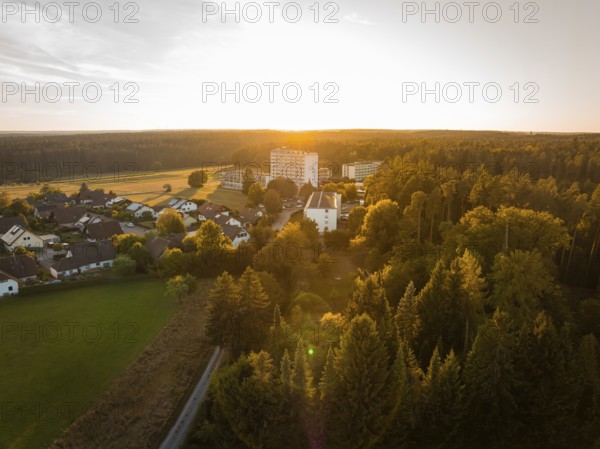 Landscape at sunset with a village and surrounding forests in warm light, fire drill in the new construction tunnel of the Hermann Hesse railway, Ostelsheim, district of Calw, Germany