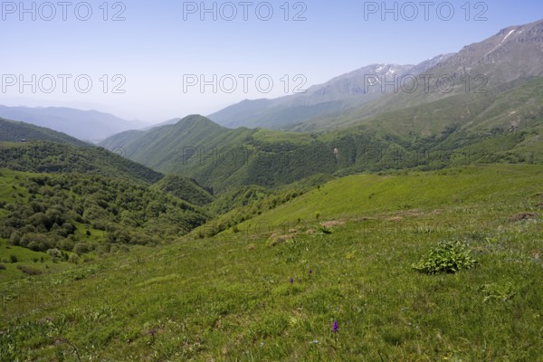 Green valley with hills and mountains under a wide sky, at the highest pass in Armenia, Meghri Pass, Tashtun Pass, Syunik Province, Syunik, Armenia