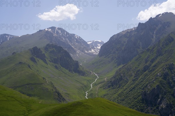 Mountain landscape with green valleys and a small river under a clear sky and clouds, at the highest pass in Armenia, Meghri Pass, Tashtun Pass, Syunik Province, Syunik, Armenia
