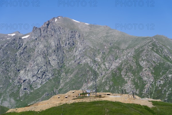 Rocks and antennas with towering mountains in the background, at the highest pass in Armenia, Meghri Pass, Tashtun Pass, Syunik Province, Syunik, Armenia