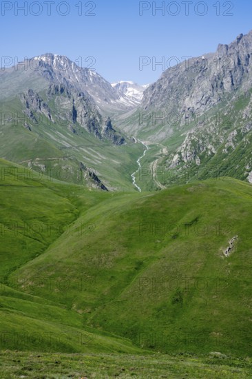 Hills and mountains with a snow-covered valley under a blue sky, at the highest pass in Armenia, Meghri Pass, Tashtun Pass, Syunik Province, Syunik, Armenia
