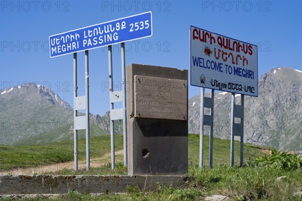 Signs on a roadside indicating the border to a place in a mountainous region, at the highest pass in Armenia, Meghri Pass, Tashtun Pass, Syunik Province, Syunik, Armenia