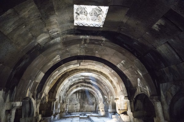 Stone vault with light opening and strong light-shadow effect, Orbelian Caravanserai, Selim Caravanserai, located at the Vardenyats Pass or Selim Pass, Vayots Dzor Province, Armenia