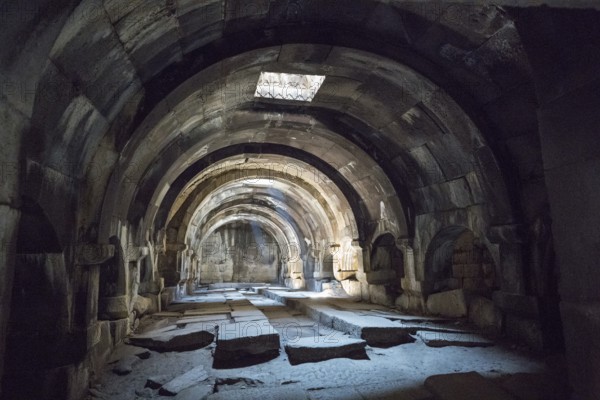 Arched, stone interior structure emphasised by light and shadow, Orbelian's Caravanserai, Selim Caravanserai, located on the Vardenyats Pass or Selim Pass, Vayots Dzor Province, Armenia