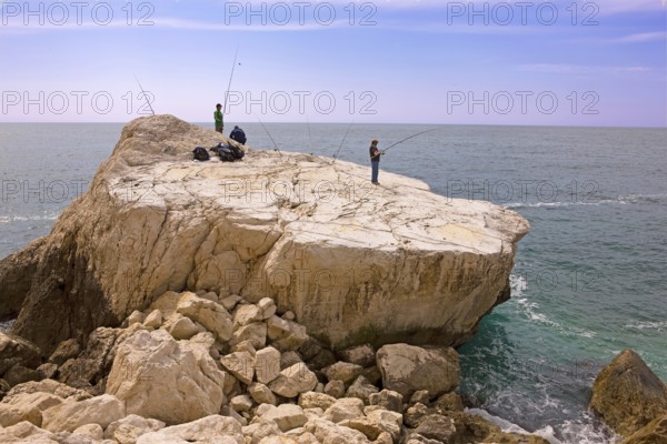 Angler, fishing, rocky plate, south at the rock Penon de Ifach landmark, Mediterranean Sea, bay, Calpe, Valencia, Costa Blanca, Spain