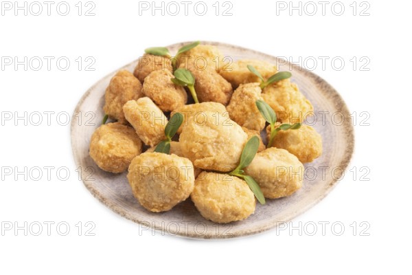 Fried crispy Chicken Nuggets with ketchup, microgreen isolated on white background. side view, close up