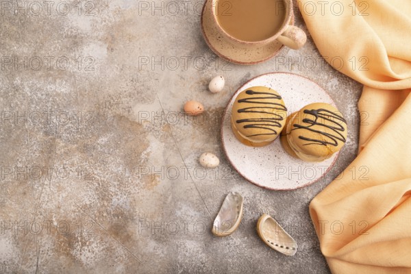 Caramel Cream Cakes on brown concrete background, cup of coffee, top view, flat lay, copy space