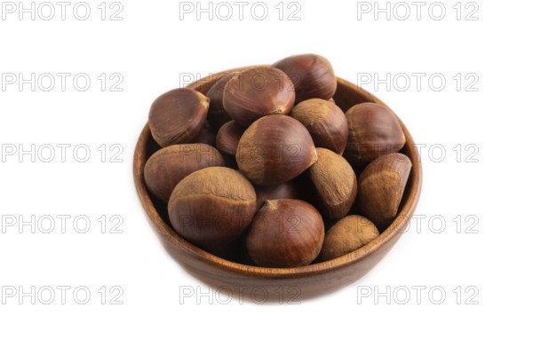 Wooden bowl with raw edible ?hestnuts Isolated on white background, side view, close up, minimalism