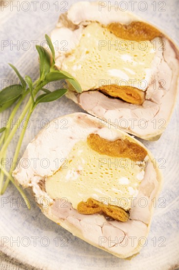Chicken, egg and dried apricot meatloaf, microgreen on brown concrete background and linen textile. side view, close up, selective focus