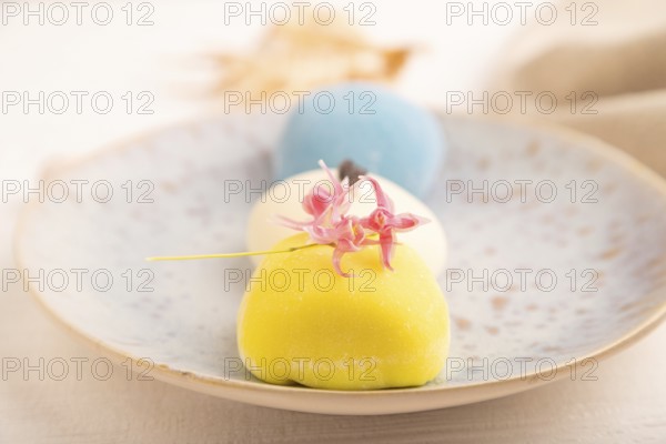 Japanese Mochi Cakes on white wooden background and linen textile, side view, close up, selective focus