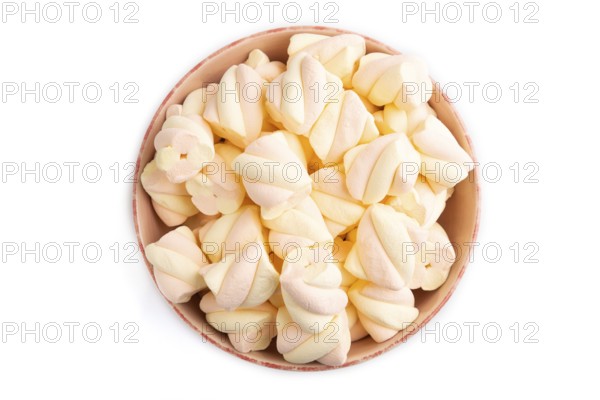 Orange and pink marshmallow in ceramic bowl isolated on white background, top view, flat lay, copy space, minimalism