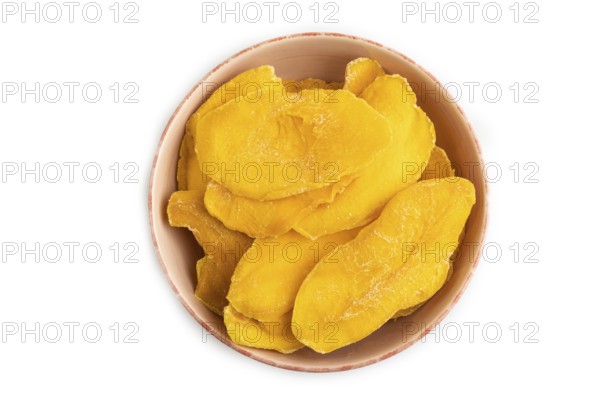Dried Mango in ceramic bowl isolated on white background. Top view, close up, flat lay. healthy food, minimalism