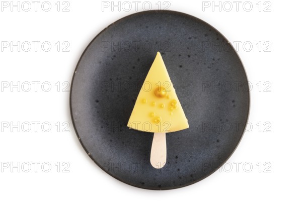 Yellow Cake pop with sprinkles on blue ceramic plate isolated on white background, top view, flat lay, close up, minimalism