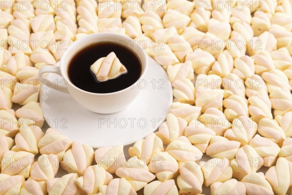 Cup of coffee on Orange and pink marshmallow background, side view, copy space, minimalism